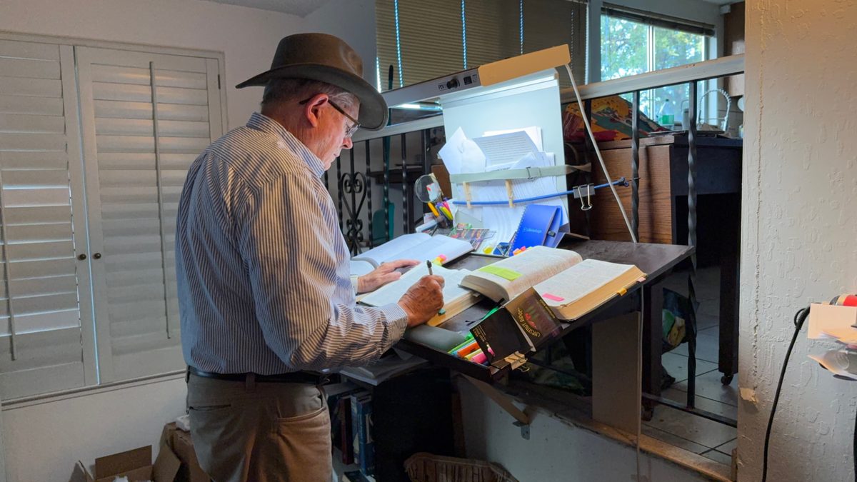 Kelly Smith at his hand-built scripture stand, marking his scriptures while standing