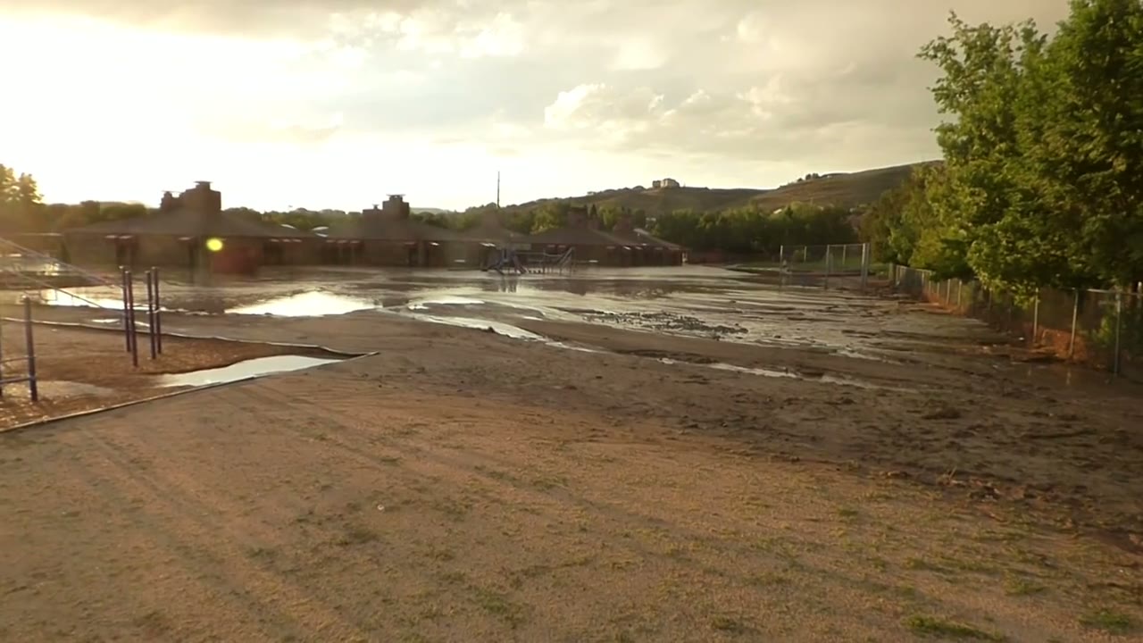Floodwater from a dry creek bed running into a Sparks, Nevada schoolyard after a flash flood